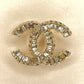 CHANEL CLASSIC CC CRYSTAL BROOCH IN GOLD TONE